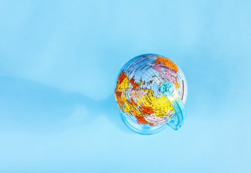 Small globe on blue background. photo