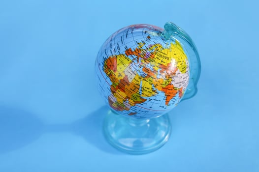 Small globe on blue background. photo