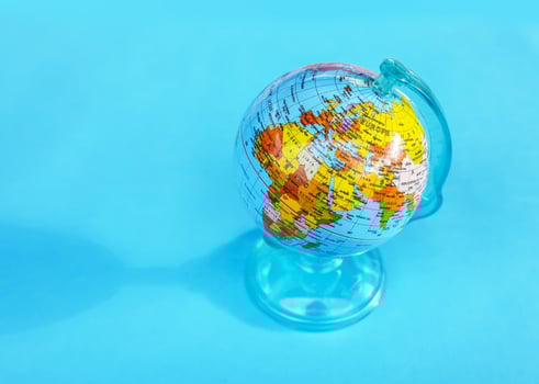 Small globe on blue background. photo