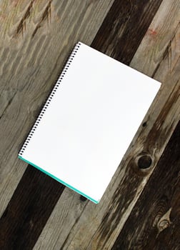 White paper sheet on the wooden table outdoors photo