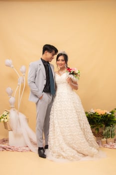 expressions of male and female couples standing relaxed laughing looking at the front of the woman intimately indoor photo shot. couple wedding national bride studio