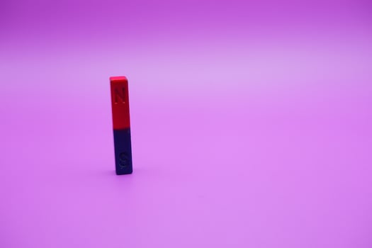 bar magnet isolated on purple background photo