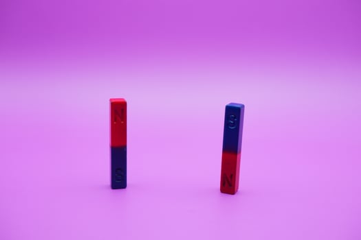 two bar magnets isolated on a purple background photo