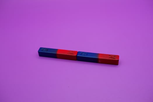 two bar magnets isolated on a purple background photo