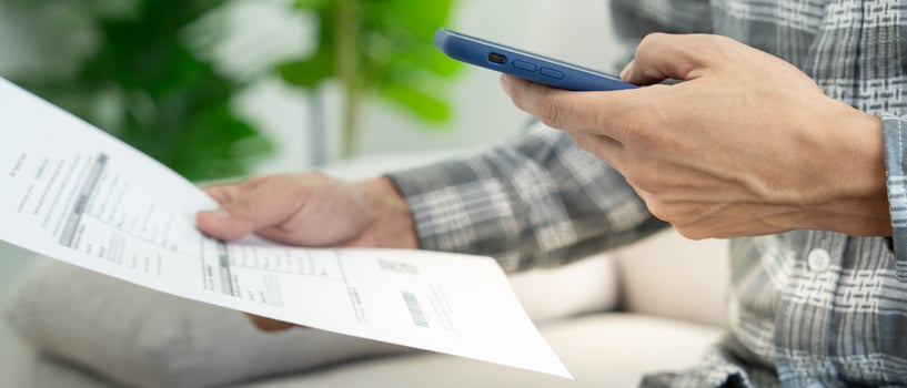 business man use phone to scan barcode or QR codes to pay credit card bill after receiving document invoice online. payment, receive, paying electricity, digital payments without money, technology photo