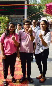 New Delhi, India - May 25 2024 - Unidentified people showing their ink-marked fingers after casting votes in front of polling booth of east Delhi area for general Lok Sabha Elections 2024 photo