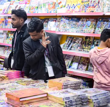 Delhi, India, June 7 2024 - Various age group people reading variety of Books on shelf inside a book-stall at Delhi International Book Fair, Books in Annual Book Fair at Bharat Mandapam complex photo