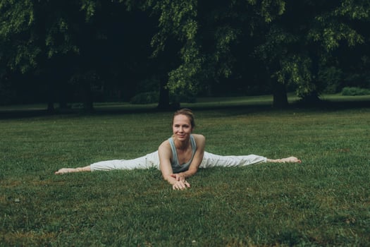 young woman athlete in sportswear practices yoga, enjoys training photo