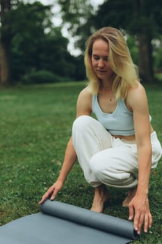 young woman athlete in sportswear practices yoga, enjoys training photo