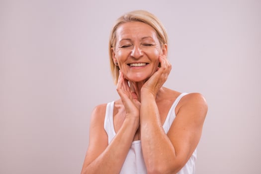 Portrait of beautiful mature woman on gray background. Beauty concept. photo