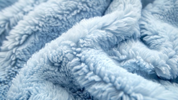A closeup of baby blue fleece showing its soft plush surface with tiny fibers creating a luxurious look and feel photo