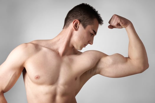man flexing biceps muscles photo