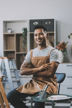 Young male artist painting picture in studio photo