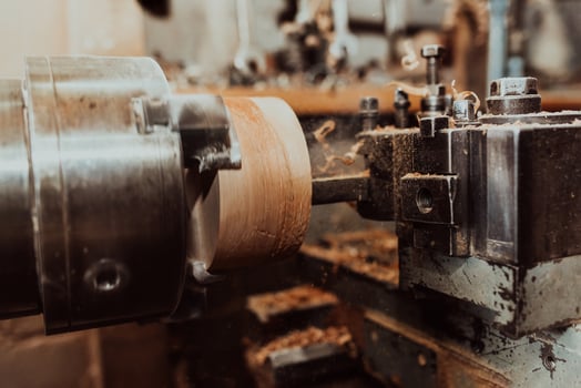 Close-up photo of a lathe working on wood. Mechanical processing of wood