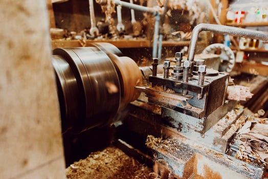 Close-up photo of a lathe working on wood. Mechanical processing of wood
