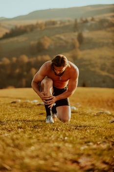 A determined athlete preparing for the start of training on the top of the mountain at sunrise. photo