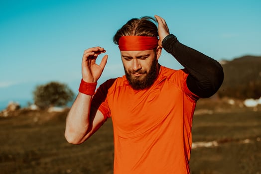 A determined athlete preparing for the start of training on the top of the mountain at sunrise. photo