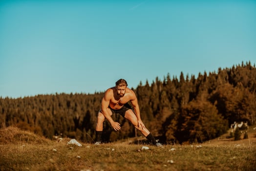 A man stretching after a hard workout in the early hours of the morning photo