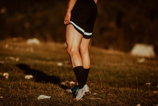 A man stretching after a hard workout in the early hours of the morning photo