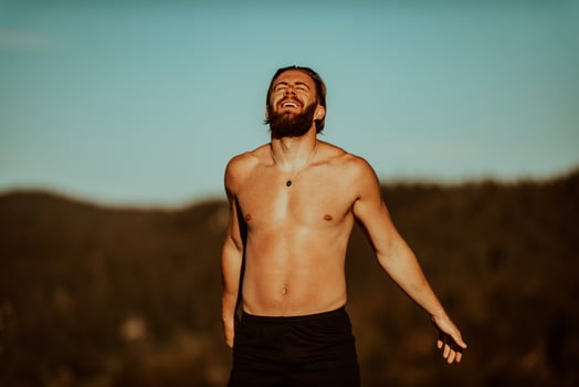 An athlete rests on top of a mountain after exhausting running training. photo