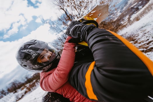 Couple enjoying while driving quad bike on top of mountain at winter time photo