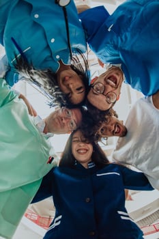 Group of doctors a medical nurse, and a surgeon are captured in a heartfelt embrace, showcasing their unity, teamwork, and profound connection in the healthcare field. photo