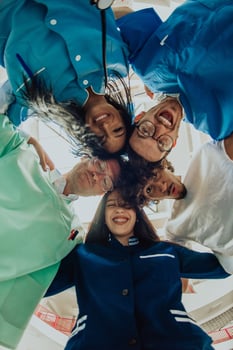 Group of doctors a medical nurse, and a surgeon are captured in a heartfelt embrace, showcasing their unity, teamwork, and profound connection in the healthcare field. photo