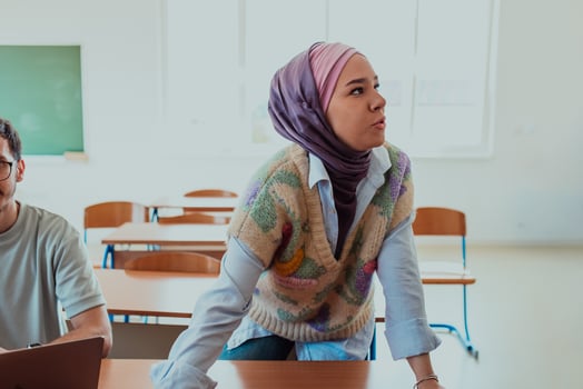 A businesswoman wearing a hijab leads a corporate meeting with a wide smile, showcasing her professionalism, confidence, and inclusive leadership in modern attire photo