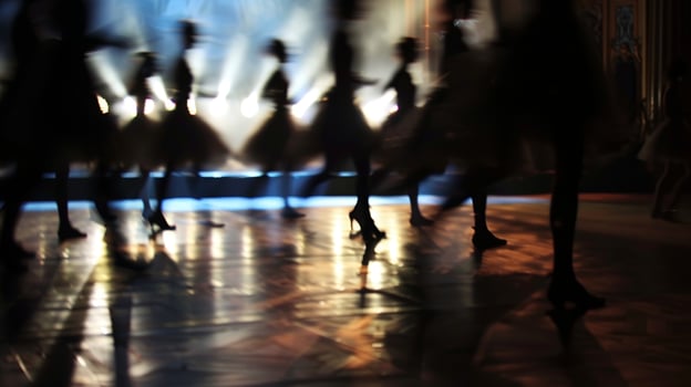 Shadows danced across the defocused stage as the audience held their breath photo