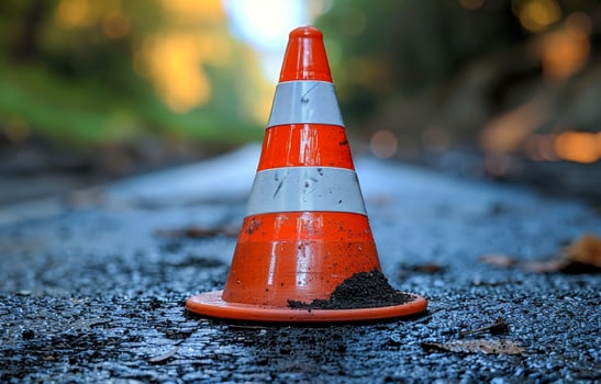 Orange Traffic Cone on Wet Pavement photo