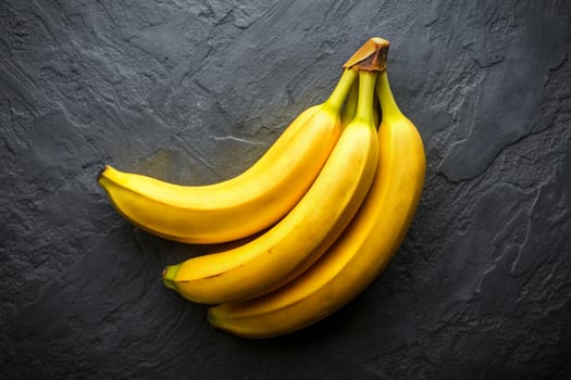 Bunch of yellow bananas on a black stone photo