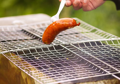 Tasty grilled sausages. Frying on brazier outdoors in the countryside at summer. photo
