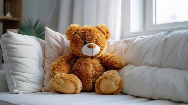 Brown Bear Sitting on White Couch photo