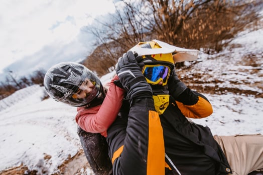Couple enjoying while driving quad bike on top of mountain at winter time photo