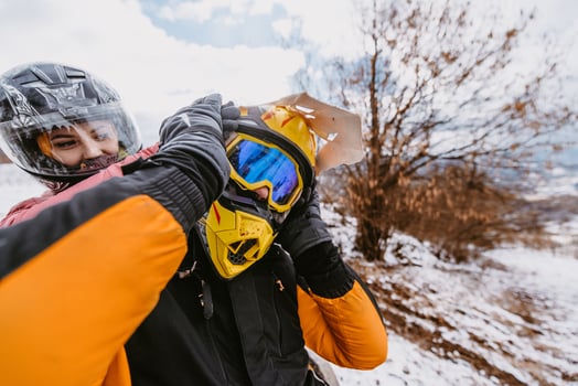 Couple enjoying while driving quad bike on top of mountain at winter time photo