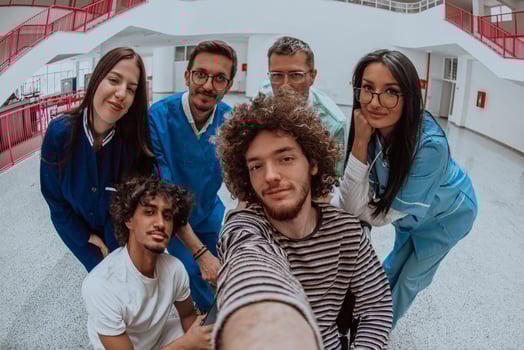 In a modern hospital hallway, a doctor and a medical nurse capture a selfie with a wheelchair patient, radiating joy, inclusivity, and the positive impact of technology in healthcare. photo