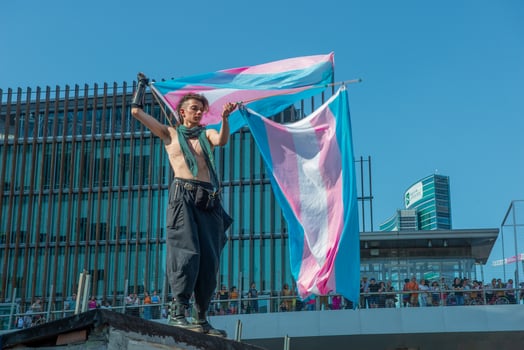 Milan Italy 2024 Transsexual girl protesting by waving the flag for gender freedom photo