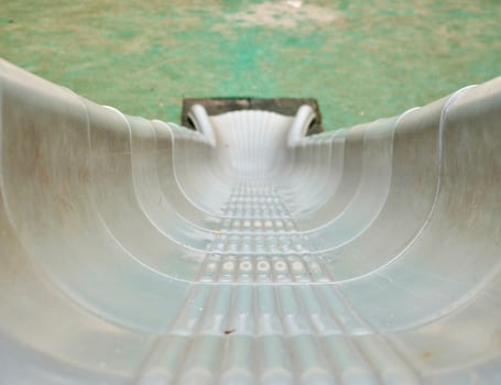 Gray colored plastic slide playground park toy isolated on horizontal ratio first person point of view background. photo