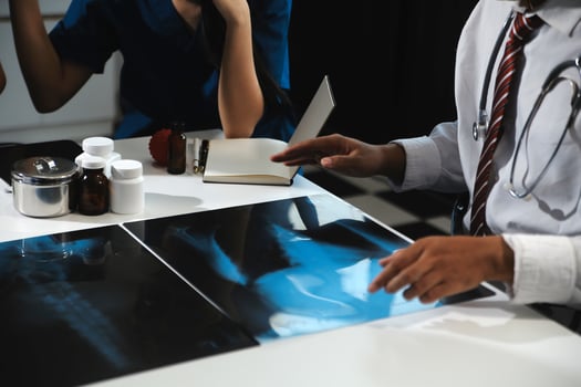 Manager Man Checking Pie Chart Data of Monthly Audit Report and Give a Negative News to his Medical Team in Hospital Boardroom Office or Healthcare Centre Meeting Room photo