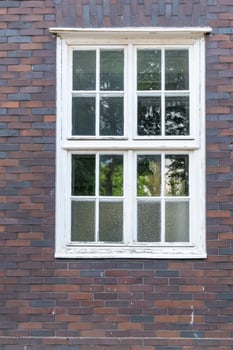 White mullioned window in brick wall photo