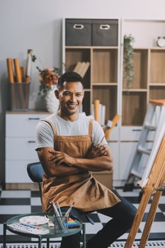 Young male artist painting picture in studio photo