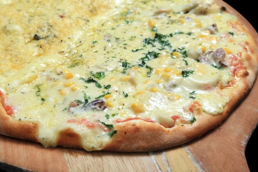 Brazilian pizza with each half with different flavors and toppings coming out of the oven photo