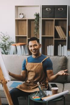 Young male artist painting picture in studio photo