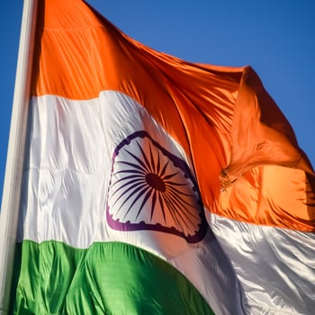 India flag flying high at Connaught Place with pride in blue sky, India flag fluttering, Indian Flag on Independence Day and Republic Day of India, tilt up shot, Waving Indian flag, Har Ghar Tiranga photo
