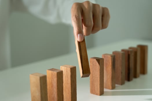 insurance with hands protect domino. Businessman hands stop dominoes falling in business crisis. business risk control and planning and strategies to run prevent insurance businesses. photo
