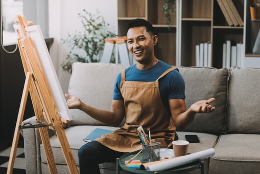 Young male artist painting picture in studio photo