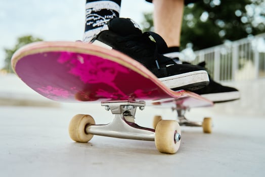 Close-Up of Skateboarder's Feet on Skateboard photo