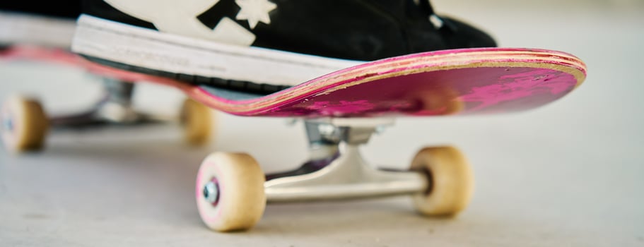 Close-Up of Skateboarder's Feet on Skateboard photo