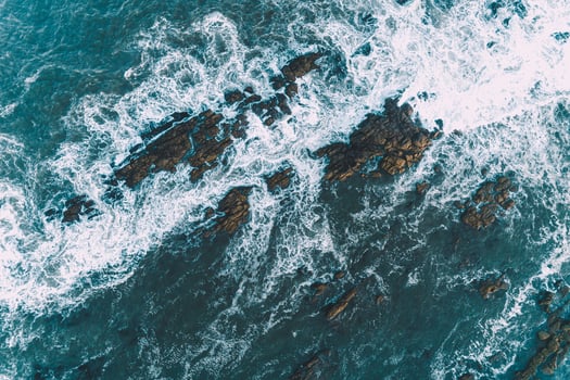 waves breaking on the rocks of the coast, aerial top view with a drone. photo