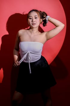 Beauty young Asian woman sexy elegant office wear black formal suit hands holding back hair and tangtop with circle spotlight concept, for fashion content, promotions, advertising photo